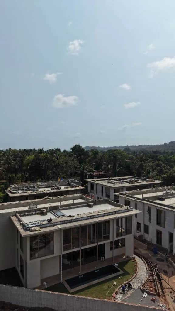 Construction progress at the Reis Magos villas, with private pools taking shape against a river view.