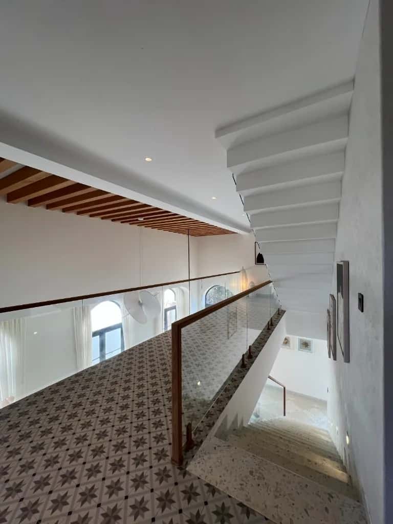 A Goan villa interior with arched windows and tropical light.