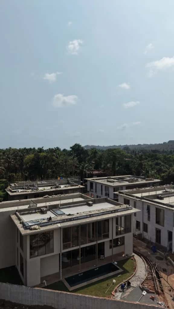 Construction progress at the Reis Magos villas, with private pools taking shape against a river view.
